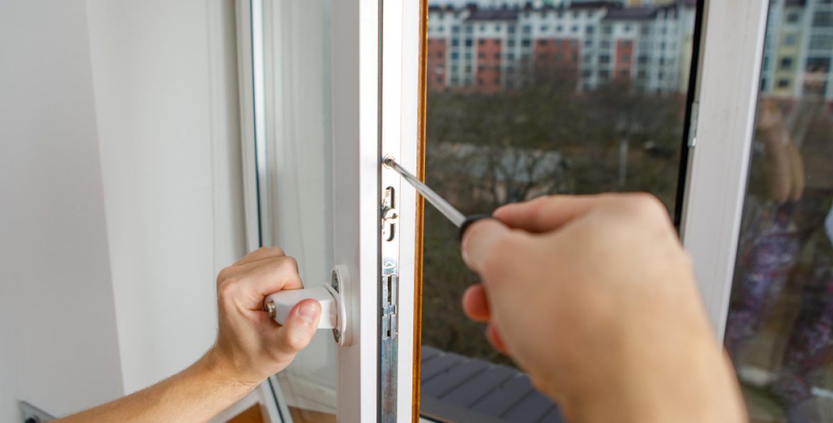 worker-installing-checking-window-house